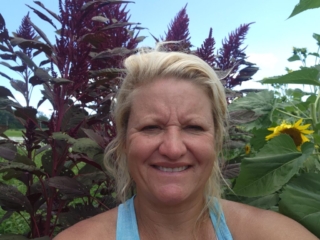 Amaranth growing behind a flower farmer